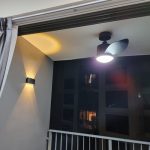 Outdoor wall light installed at balcony with warm white beam