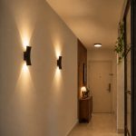 Black hallway wall light with warm up-and-down beam