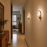 Gold ring round wall light in hallway with warm white glow, 20cm circular wall light in gold finish