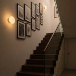 Lysa glass round wall sconces along stairway gallery wall in landed home
