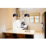 Modern hanging lights in black and rose gold above kitchen island in Singapore home