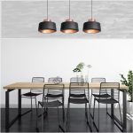 Modern hanging lights in black with 3 pendant layout above dining table