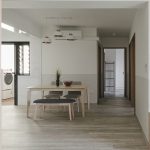 Modern hanging lights installed above dining table in Singapore home interior