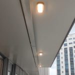 Bulkhead outdoor ceiling light installed along Singapore condo balcony corridor