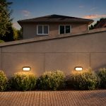 Megaman bulkhead outdoor wall light installed on landed house boundary wall at dusk