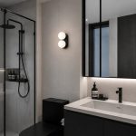 Black Pearl wall with light in modern condo bathroom