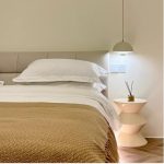 japandi pendant light beside bed in cream colour