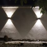 Outdoor wall light with warm white beam on garden wall