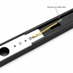 Track light rail with groove to hide wire