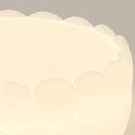 Clara LED ceiling light close-up showing softly diffused warm white light through acrylic lampshade