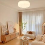 Clara round LED ceiling light in living room with soft warm white glow and acrylic lampshade