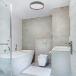 Orion grey round LED ceiling light installed in modern bathroom with daylight 6000K illumination