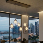 Dining pendant light in clear glass 6-light cluster above dining table