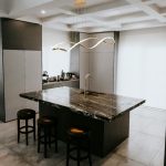 Auralis pendant ceiling lights in gold finish above a modern kitchen island with marble countertop