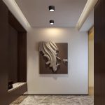 Black surface mounted downlight LED ceiling lights installed in modern hallway highlighting wall art