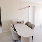 White LED pendant light with wood accent above marble table for pendant lighting for kitchen island