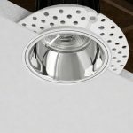 Eryx trimless downlight with silver inner reflector installed in false ceiling cutaway view