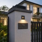 Grey LED step light mounted on landed property gate pillar illuminating house number sign